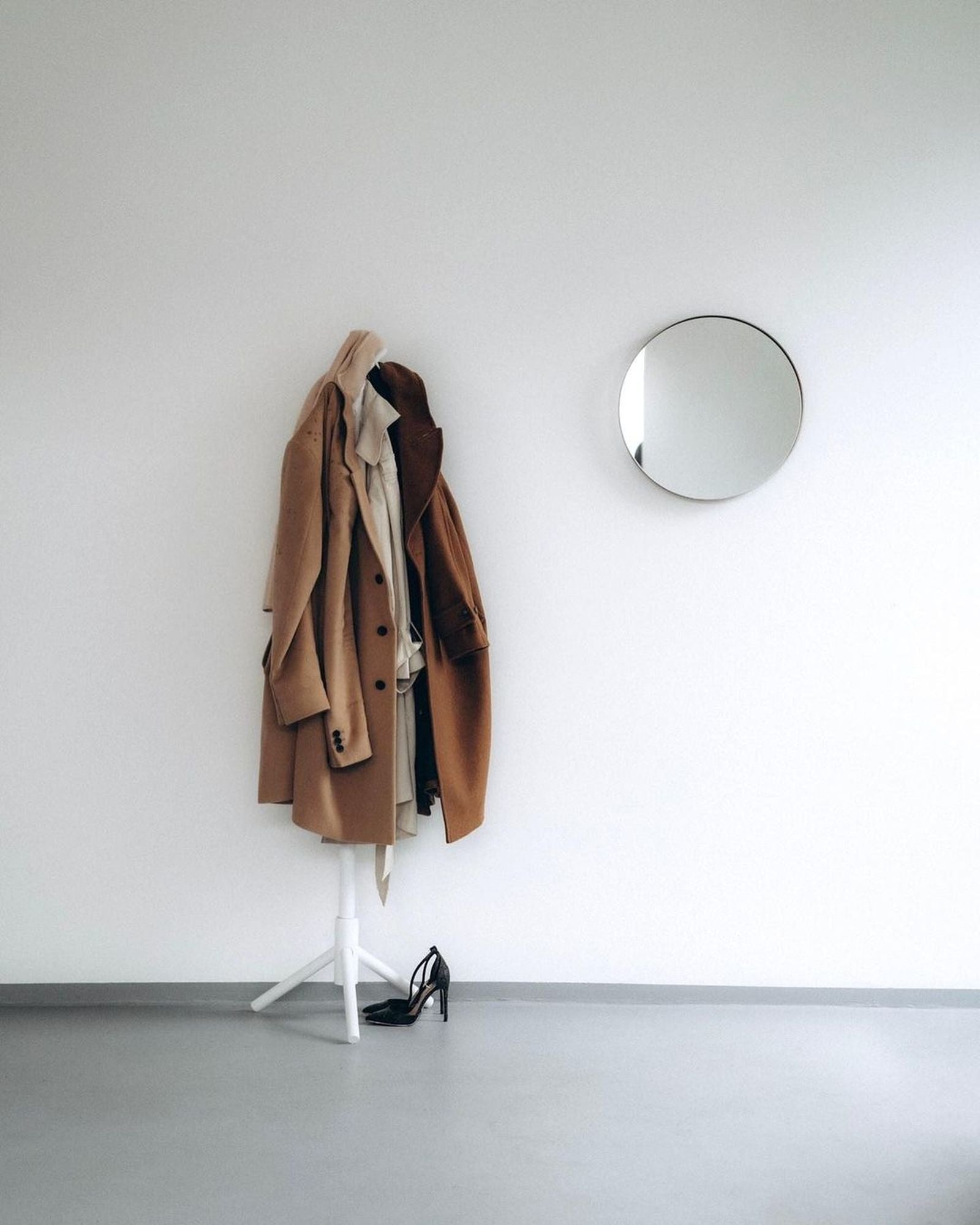 Camel coats hanging on a garment stand