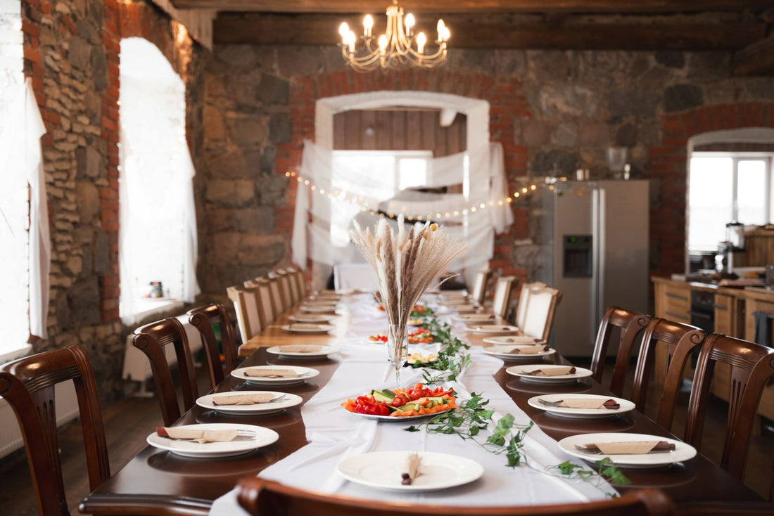 A long table set with plates and silverware