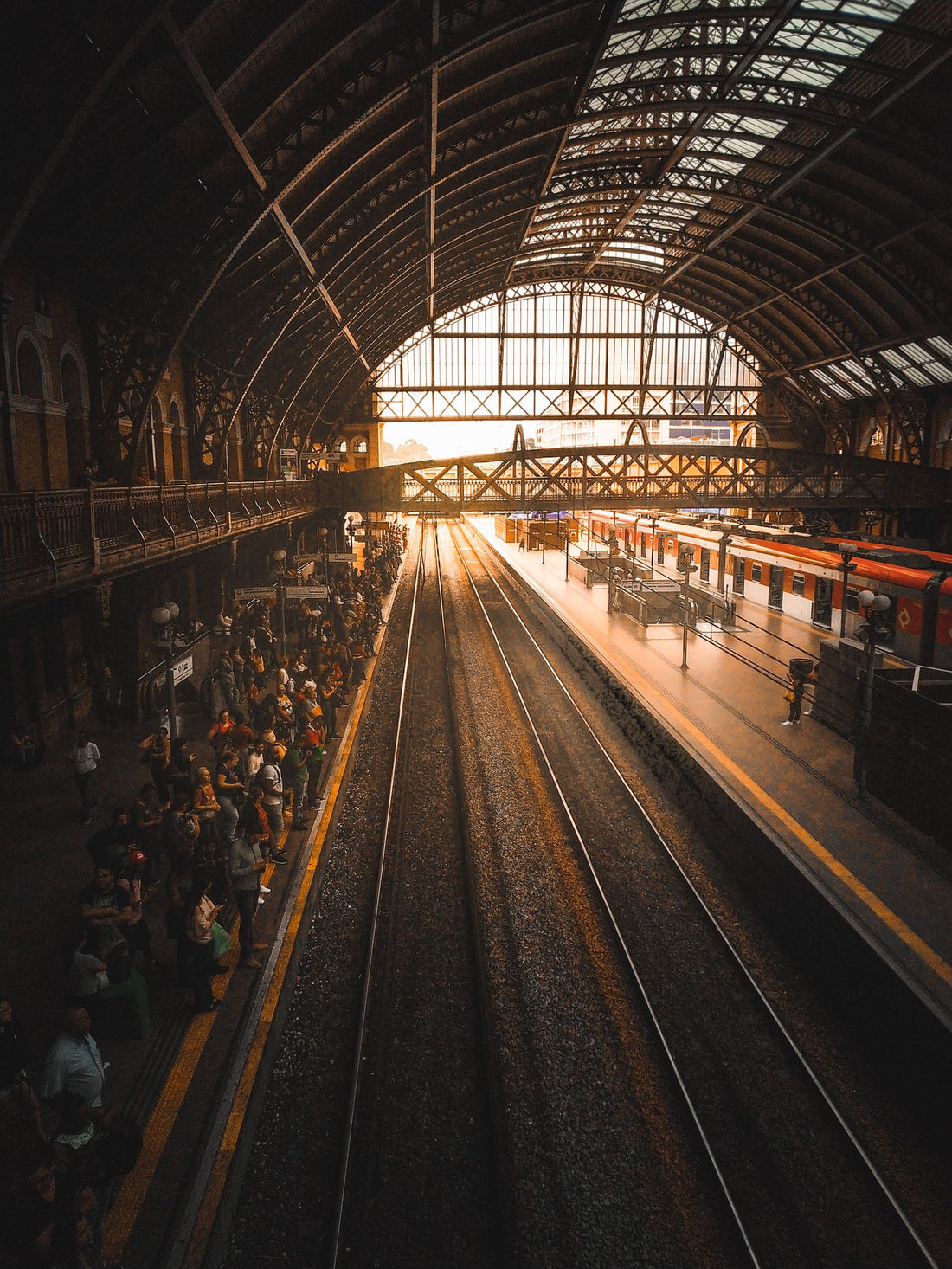 A crowd of commuters waiting at a train station