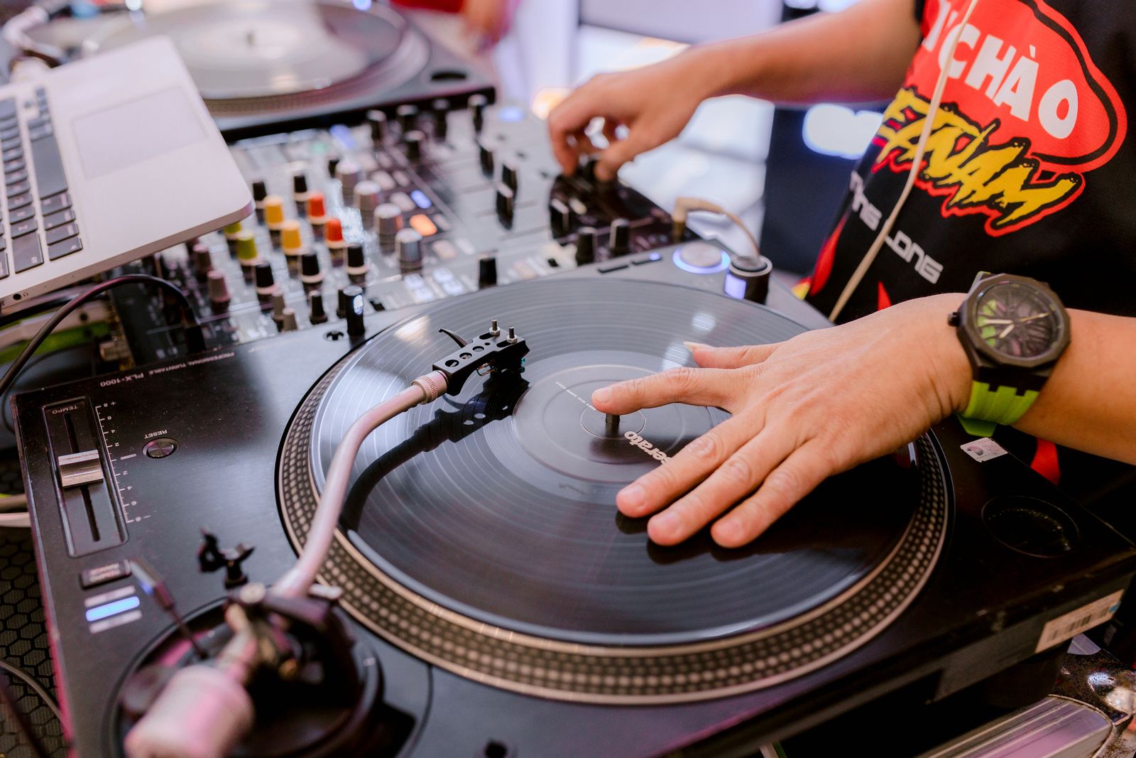A DJ spinning vinyl at a music event