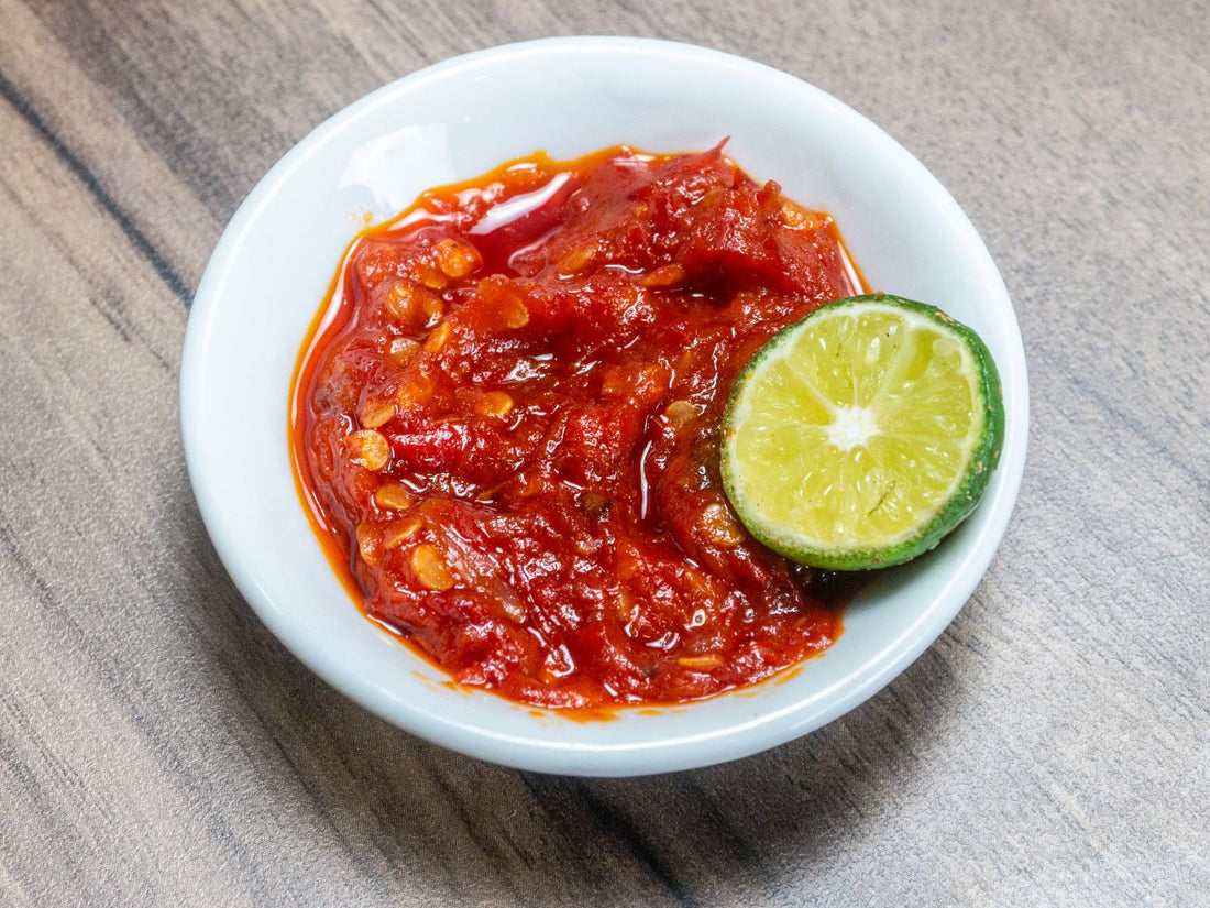 Indonesian sambal with lime on a wooden table