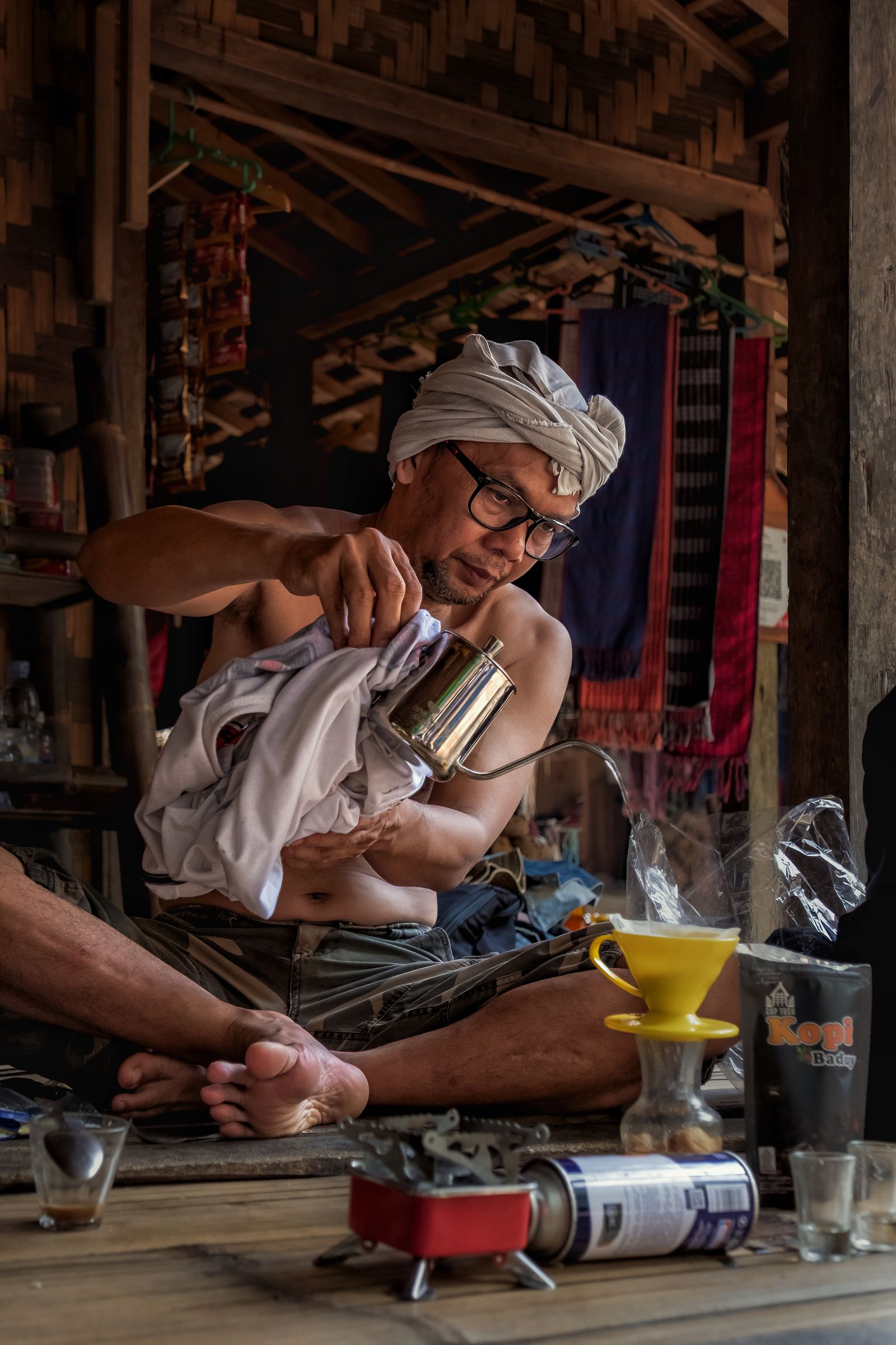 Traditional coffee brewing in a rustic Indonesian setting