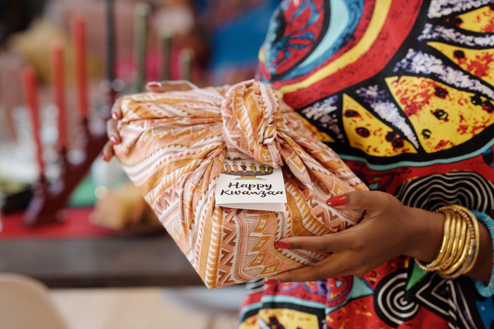 A gift wrapped in cloth held in two hands