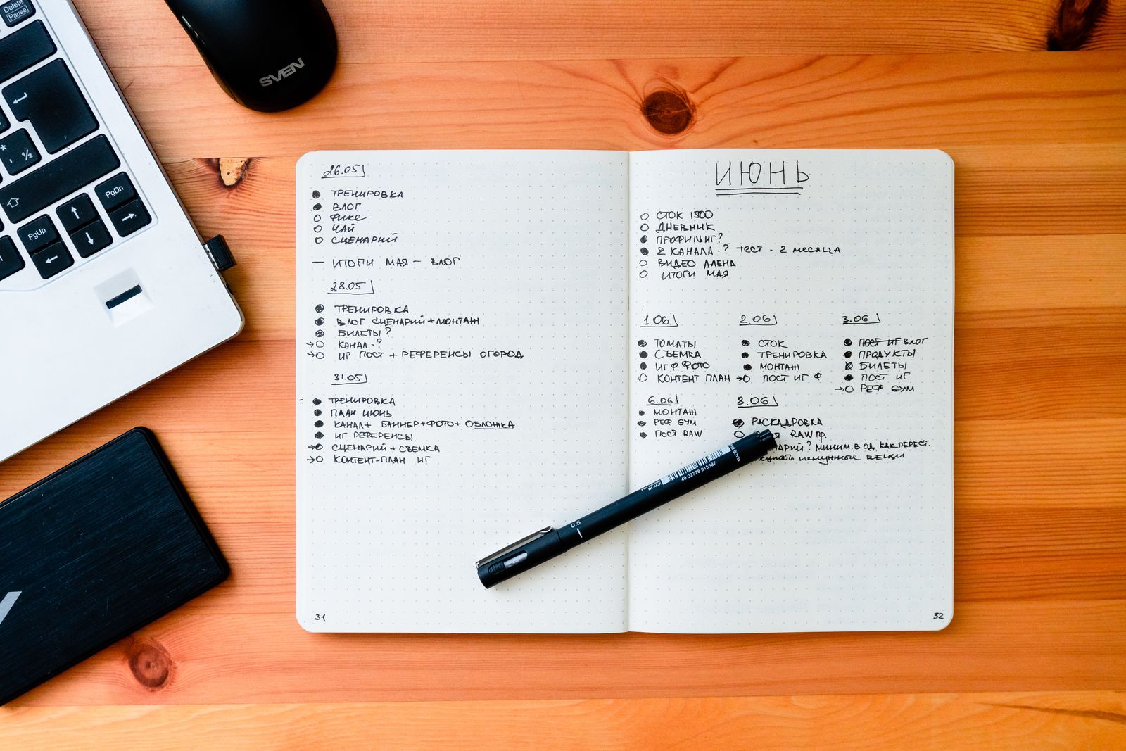 An open notebook with pen on a desk