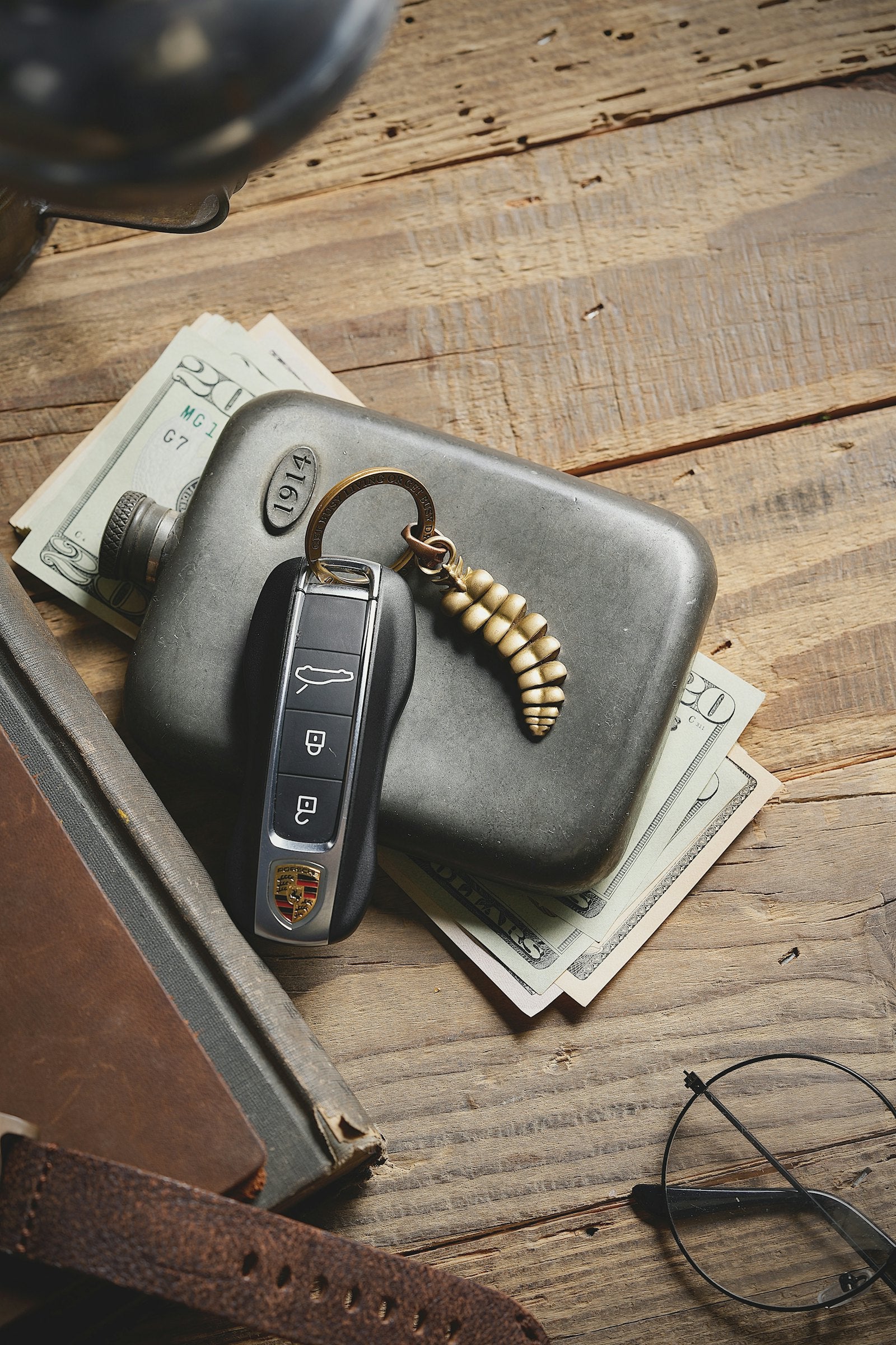 Wallet, keys and sunglasses laid out on a table