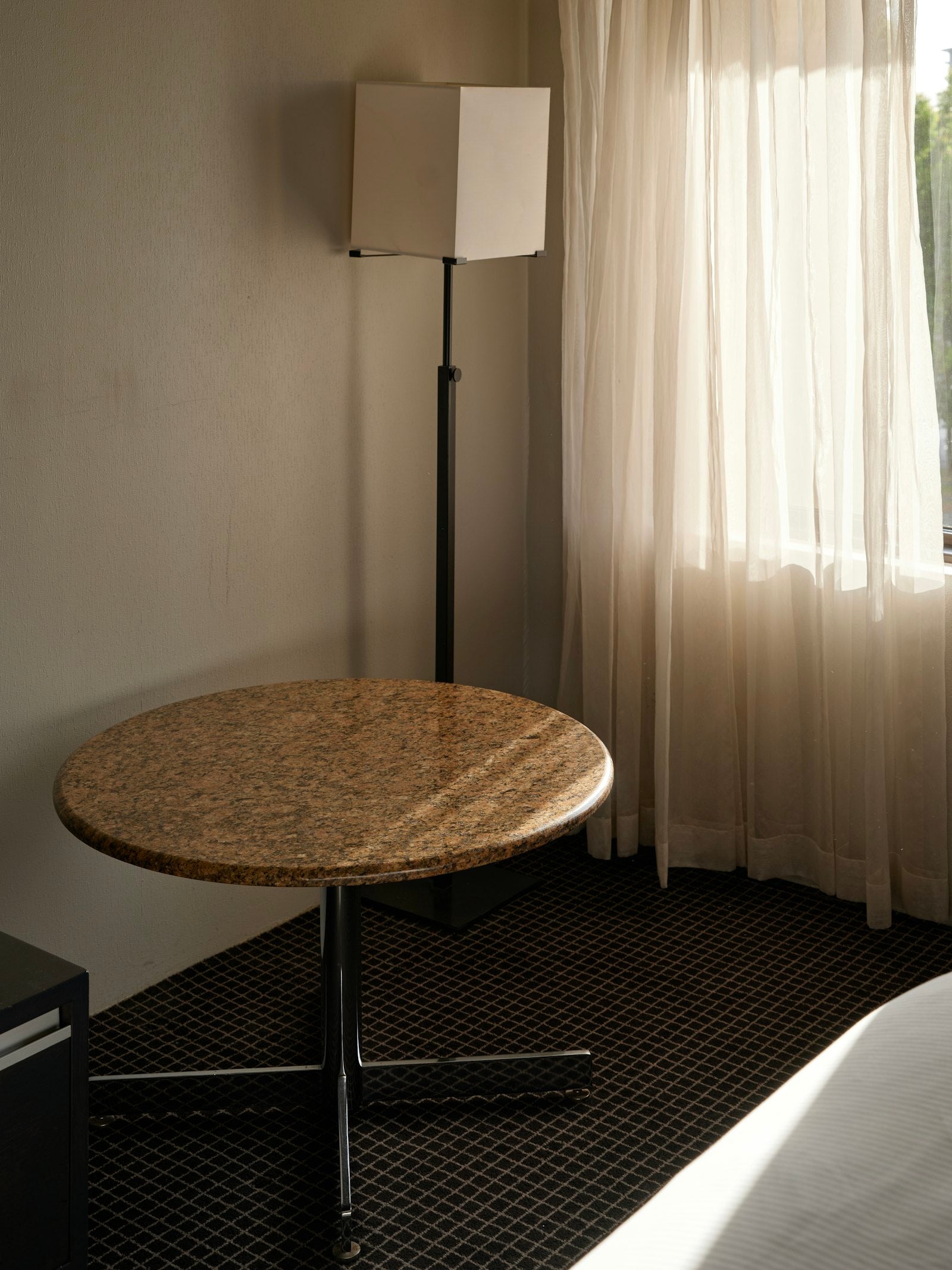 A table lamp and window lighting a quiet room